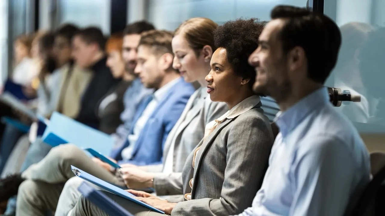 A row of professionals seated and engaged at a leadership session